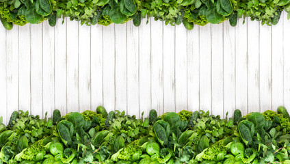 banner. Fresh fragrant green mix herbs on a white wooden background. basil, cilantro, peppermint, spinach, salad, arugula. copy space, flat lay