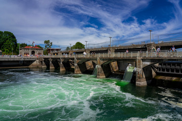 Turquoise water churns beneath the spillway of the Ballard Locks between Puget Sound and Lake Union in Seattle, Washington. 