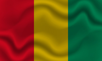 national flag of Guinea on wavy cotton fabric. Realistic vector illustration.
