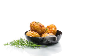 whole fried young potatoes in a pan