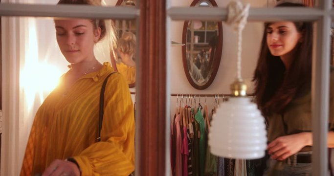 Two young women shopping in a vintage boutique store