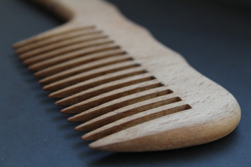 Wooden comb on a dark background