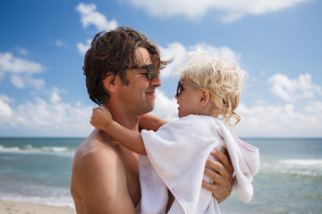 happy family father and daughter relax and play by the sea on the beach in summer