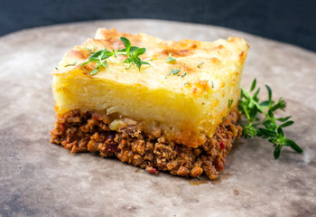 Traditional English shepherd pie offered as closeup in a rustic modern design plate