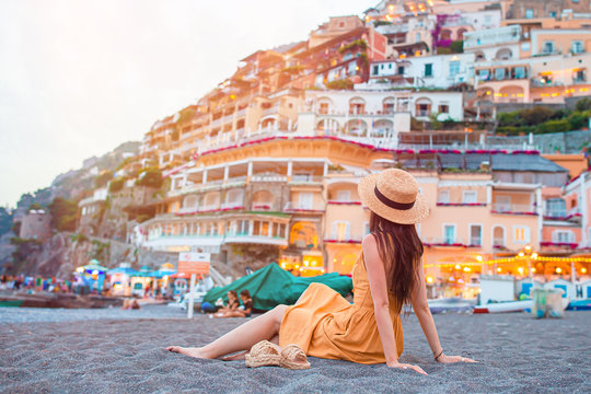 Summer holiday in Italy. Young woman in Positano village on the background, Amalfi Coast, Italy