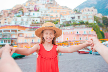 Fototapeta premium Adorable little girl on warm and sunny summer day in Positano town in Italy