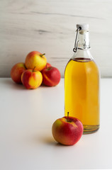 A glass bottle of apple juice, cider, vinegar
