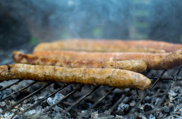 Grilled pork and beef sausages. Close up. Barbeque in nature. Delicious meat