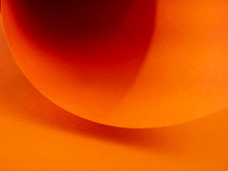 Abstract bright orange paper background for your design. Three-dimensional geometric image. Selected sharpness.