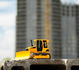 Toy bulldozer in the construction site © rootstocks
