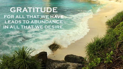 Inspirational quote - Gratitude for all that we have leads to abundance in all that we desire. Gratefulness and happiness concept on background of beautiful beach and sea landscape.