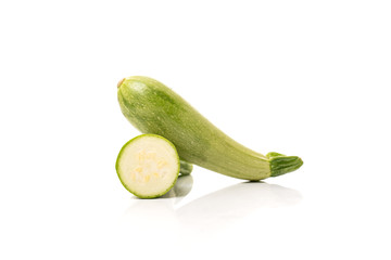 Sliced fresh zucchini, two parts of ripe vegetable on a white background