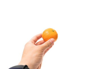 Male hand holds fresh mandarin isolated on white background with copyspace