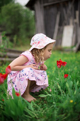 little girl playing with flowers