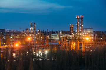 Chemical factory at summer night. Rectification towers