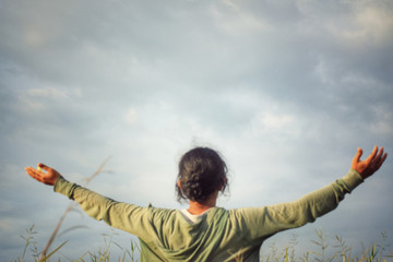 Happy young woman with arms outstretched against blue sky background. Grateful and freedom concept. Copy space for your text or design. © Maria Marganingsih
