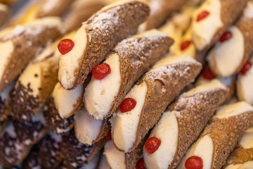 Cannolo is a typical dessert from Sicily, sweet cream tubes, street food, pastry, confectionery, closeup 