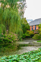 landscape with water and building in sculpture garden NJ, US