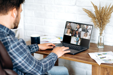 Video call. Online business meeting in video conference in the zoom app. A young attractive guy...