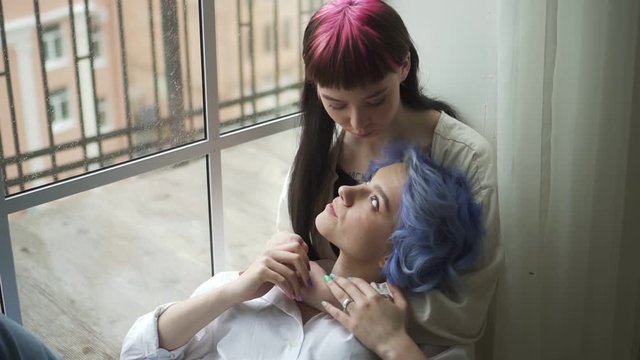 ager lesbian young womans looking at window relaxed. Spbd embracing woman portrait. beautiful tender friends females young womanfriends on sill. concept closeness, chilling, hugging