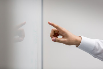 Cropped image of businessman pointing at whiteboard in office