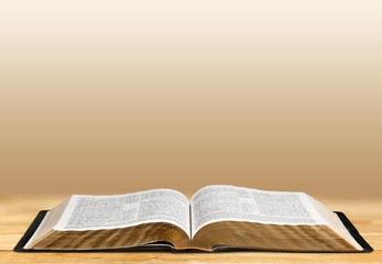 Open book on old wooden table.