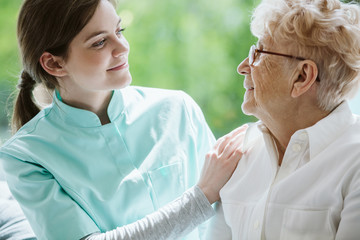 Happy senior woman and helpful caregiver, nursing home concept photos