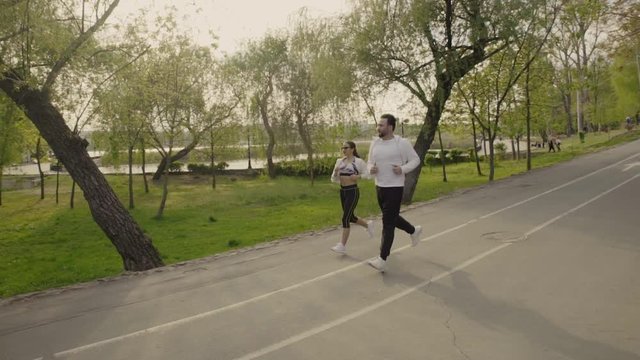 Young couple walking in the park slow motion