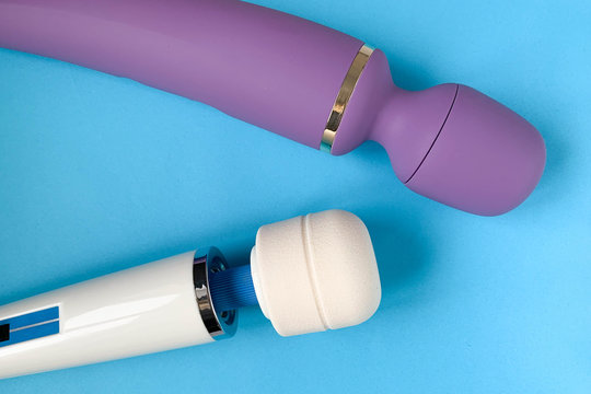 Sex toys. Two Vibrators on a blue background. Big masseur for intime. Useful for adult
