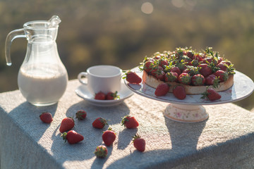 Table on the nature with a view of the mountains in the setting sun.