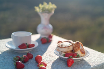 Table on the nature with a view of the mountains in the setting sun.