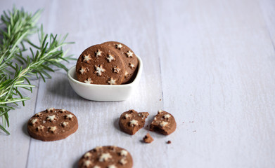 Homemade crispy cocoa and hazelnut brown round cookies on vintage table