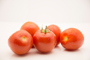 Fresh red tomato on white background.
