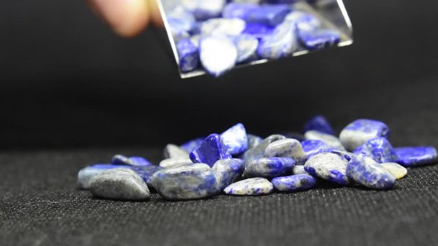 Lapis Is a beautiful natural gemstone on a wooden floor	