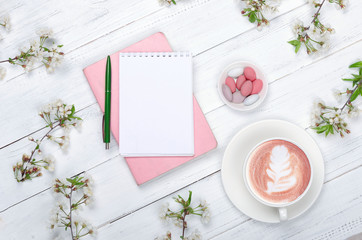 Creative flat lay of workspace desk, notepad and lifestyle objects on wooden background