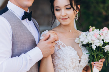 The guy and the girl are smiling at each other. Classic young wedding couple.