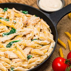 Chicken Alfredo Pasta with Spinach. Selective focus.