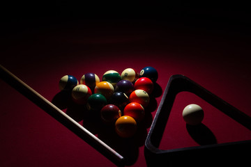 Billiard balls on a red felt pool table