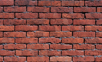 The wall is made of old red brick rough fired
