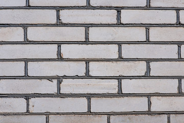 The wall is made of old white brick rough fired