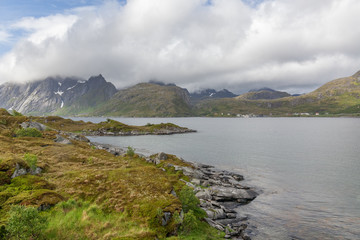 Fototapeta premium End of fjord. Beautiful Norwegian landscape. view of the fjords. Norway ideal fjord reflection in clear water In cloudy weather. selective focus