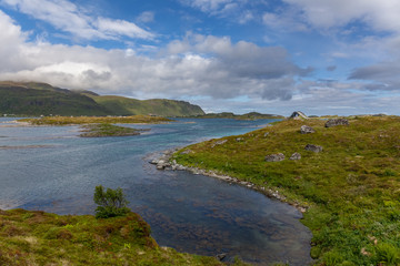 Beautiful view of the Norwegian fjords with turquoise water surrounded by cloudy sky, selective focus