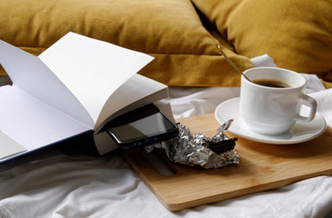 coffee with chocolate while reading a book in the bed.