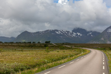 road passing in a valley between mountains in Norway, selective focus
