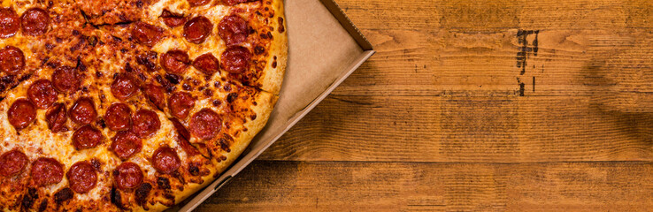 Pepperoni Pizza on Wooden Background. Selective focus.