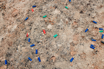 used ammunition cartridges on a soil. 12 mm. background