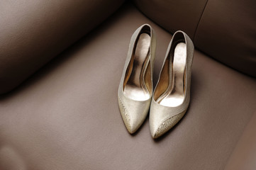 wedding shoe on brown sofa