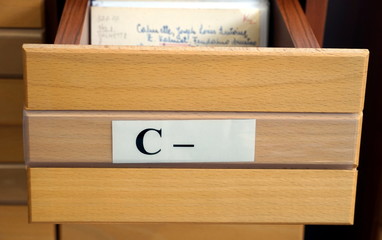 Naklejka na ściany i meble Letter C on an open drawer of a wooden library catalog