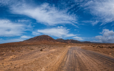 The beautiful volcanic landscape of the Las Talahijas with road on the island of Fuerteventura. Canary Islands. Spain. October 2019