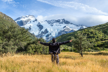 Fototapeta premium Man with open arms during at Mount Cook, New Zealand ..